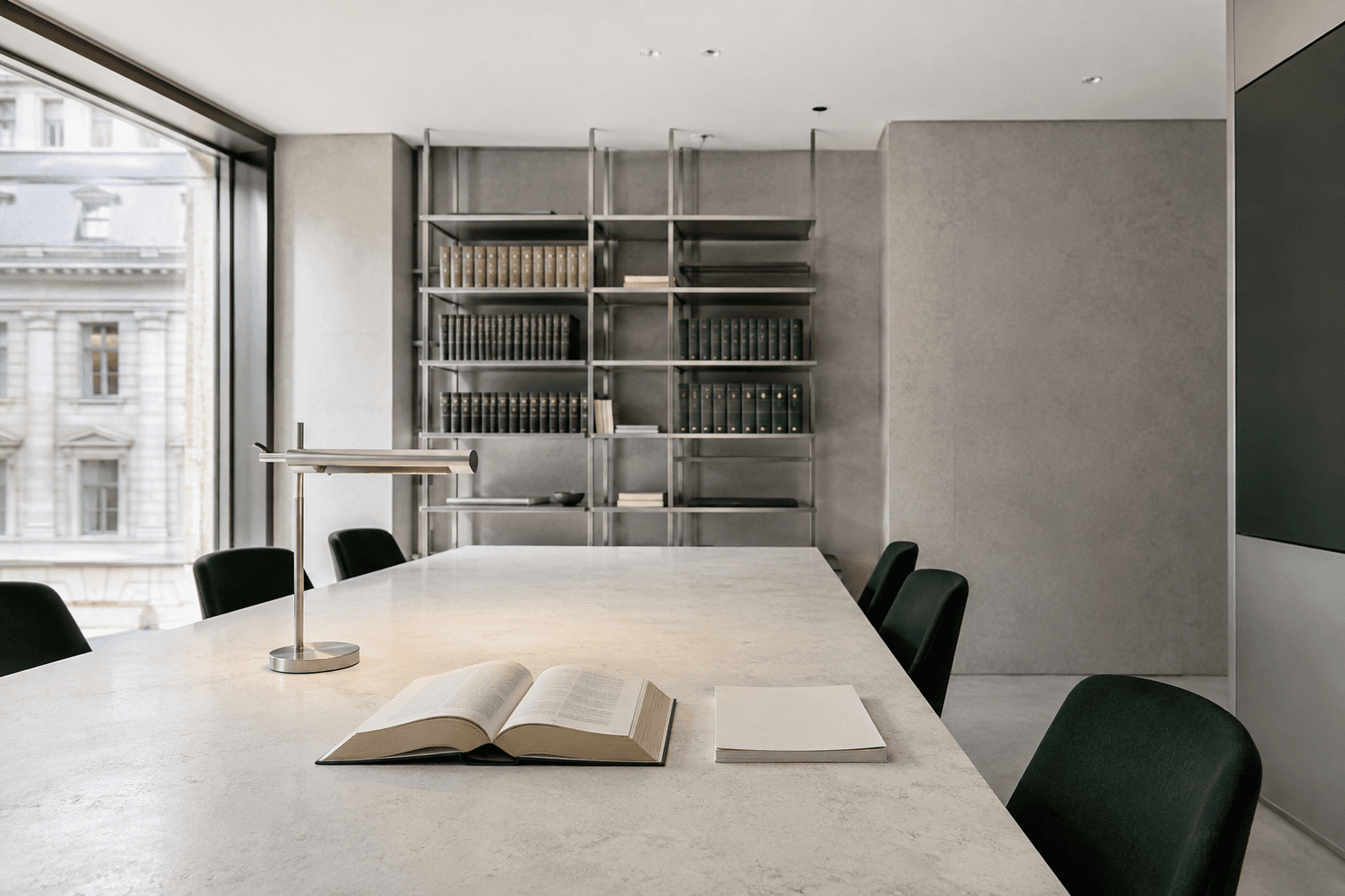 Architectural concept of a shared legal workspace, with reference books and a sunlit meeting table